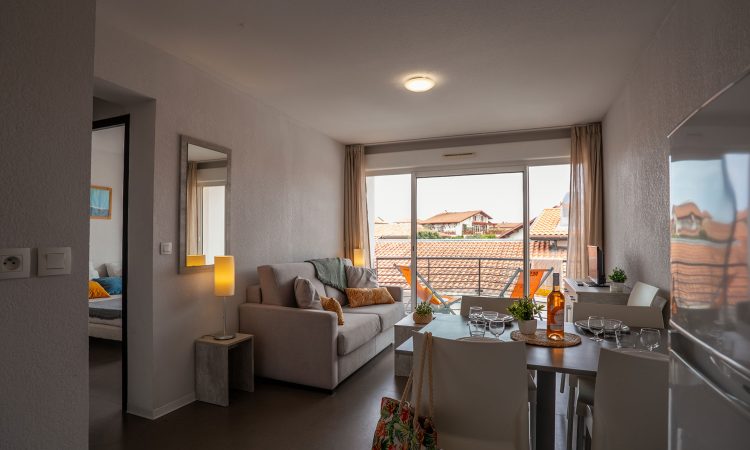 Appartement T2 cabine à Hossegor avec séjour accueillant et belle ouverture vers l’extérieur.